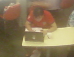 Man using a HP laptop with an Apple sticker